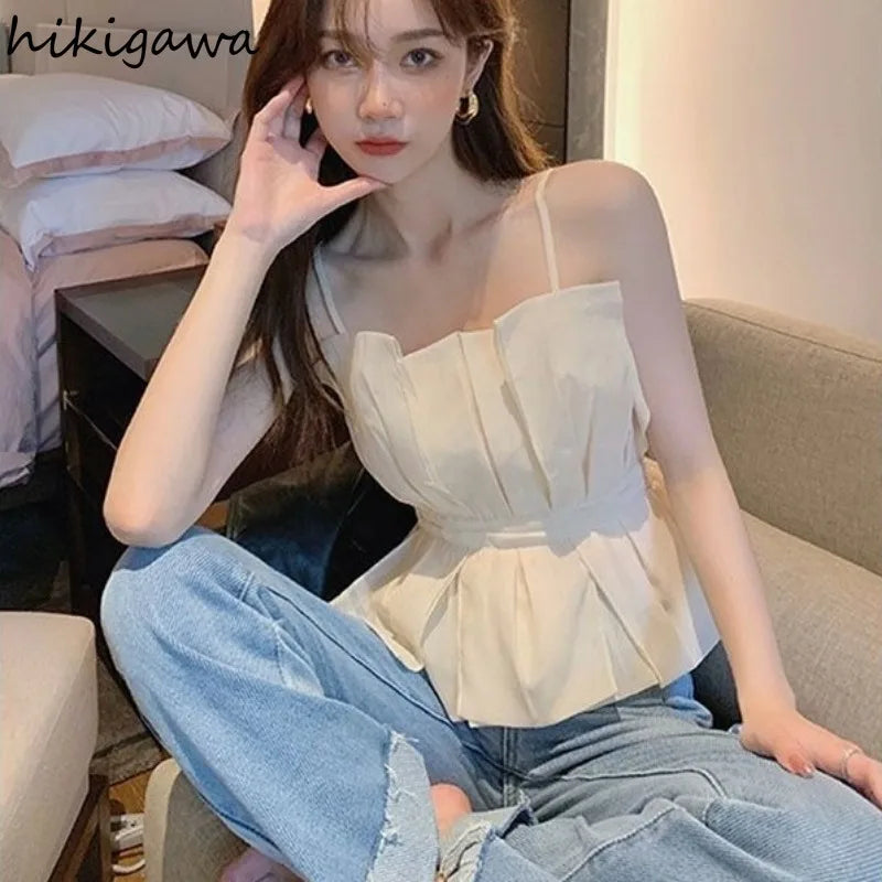 White pleated peplum top with straps and slim waist design