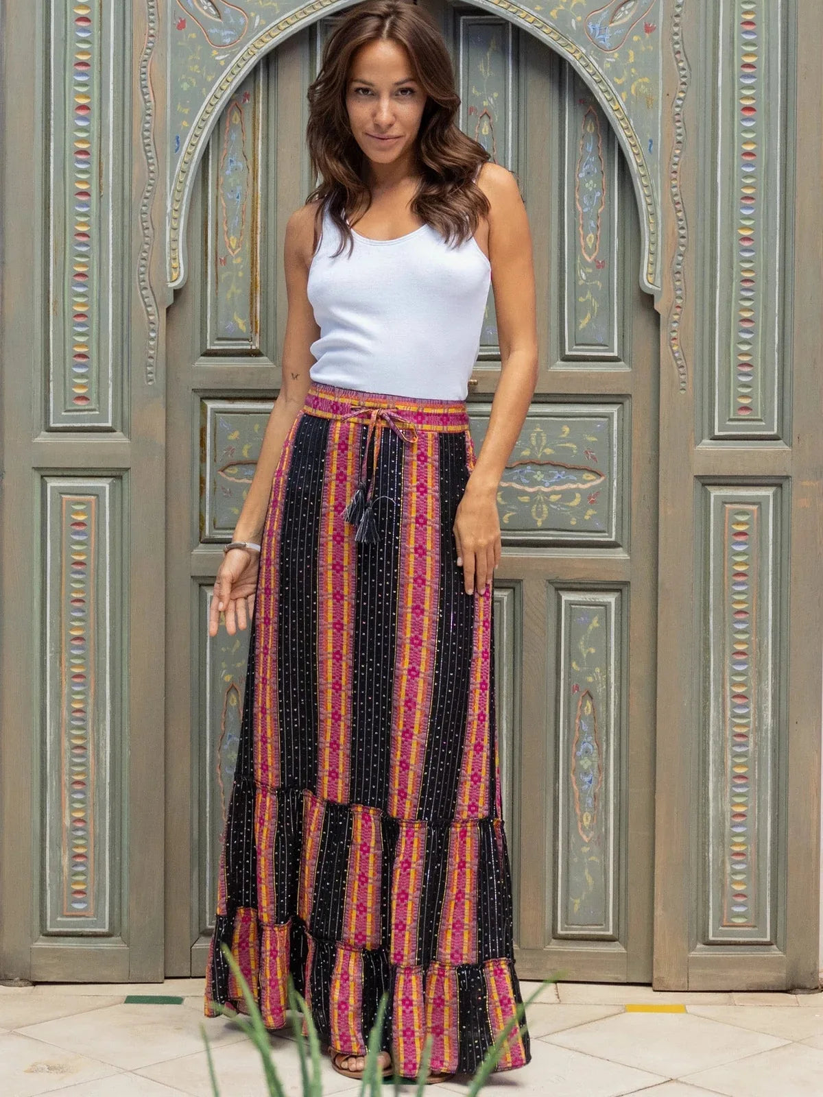 Black and pink striped boho maxi skirt with tiered hem styled with white tank top