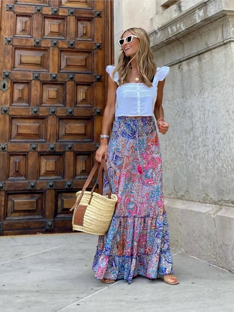 Blue and pink paisley print boho maxi skirt with tiered hem styled with white ruffle crop top