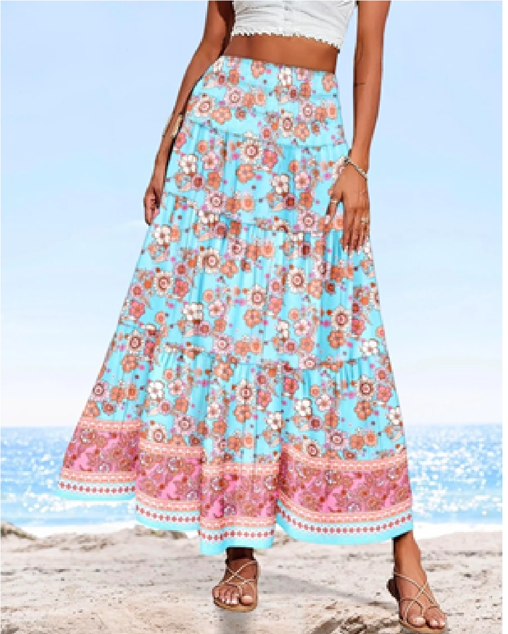 Skyblue floral border print maxi skirt with pink flowers and a tiered ankle-length silhouette, shown from the front.