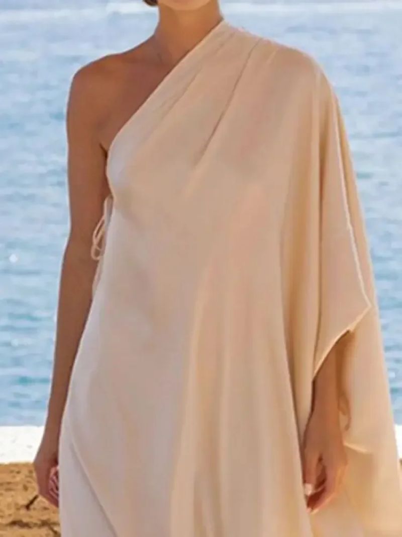 Elegant beige one-shoulder flowy long dress, perfect for modest resort or evening wear by Grace & Modesty