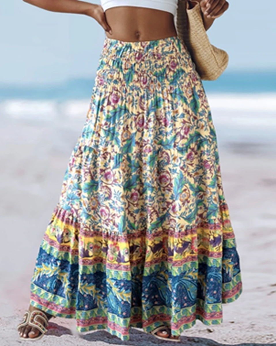 Yellow, blue and green floral border print maxi skirt with a smocked waist, shown from the front.