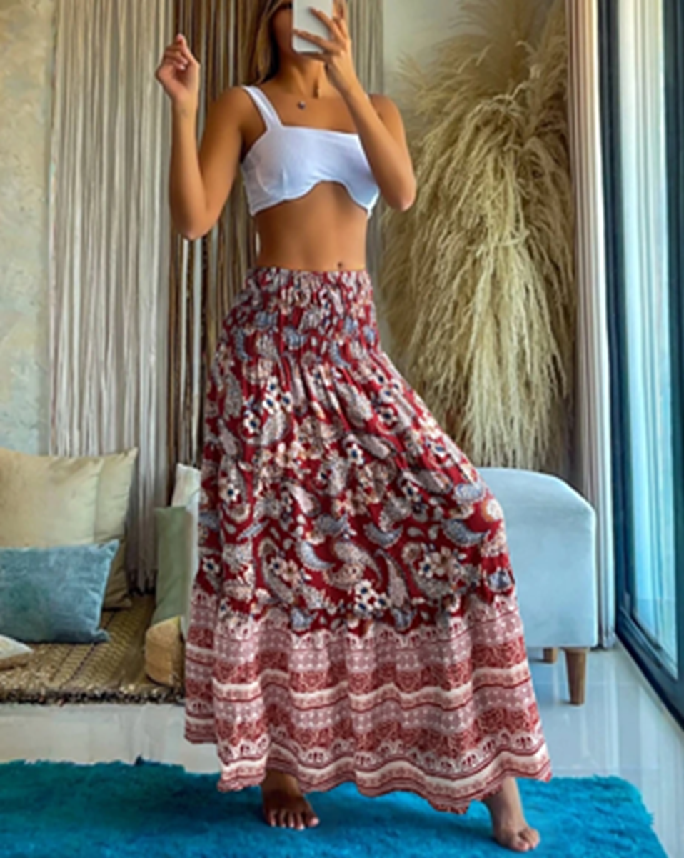 Red and cream floral border print maxi skirt with a smocked waist, shown from the front.