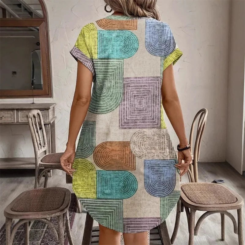 Back view of multicolor geometric print knee-length dress with short sleeves.