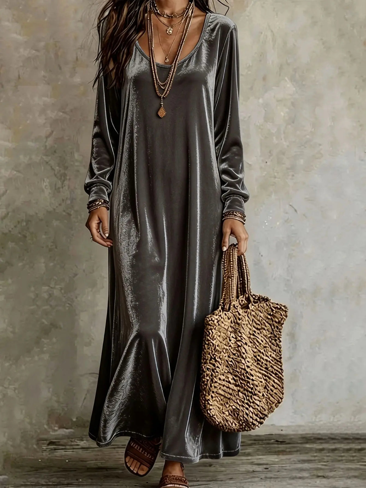 Model wearing a gray velvet maxi dress with long sleeves, a round neckline, and a relaxed fit.
