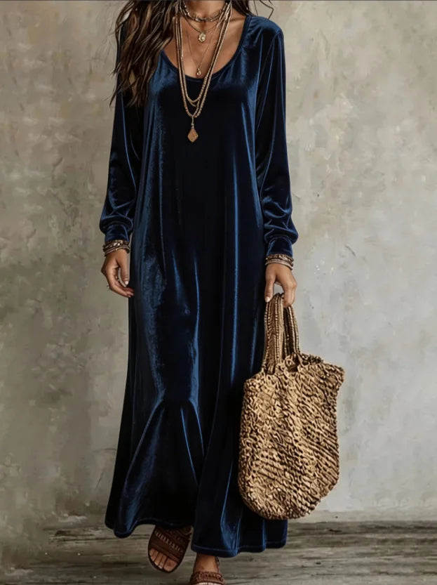 Model wearing a navy blue velvet maxi dress with long sleeves, a round neckline, and a relaxed fit.