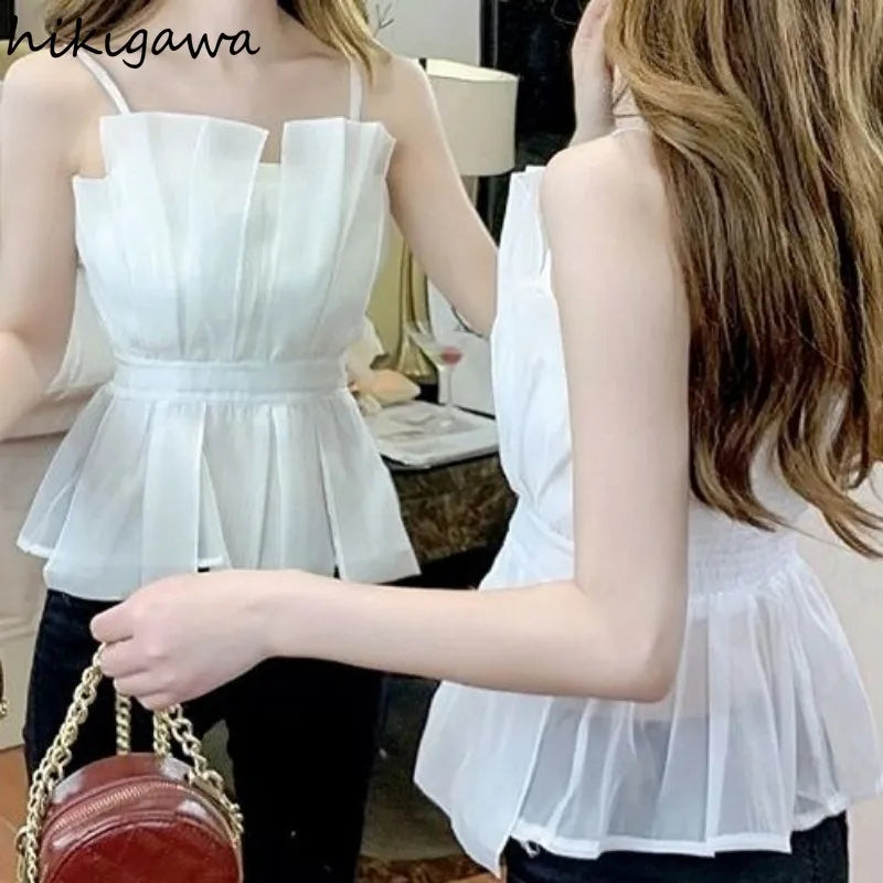 White pleated peplum top with straps and slim waist design